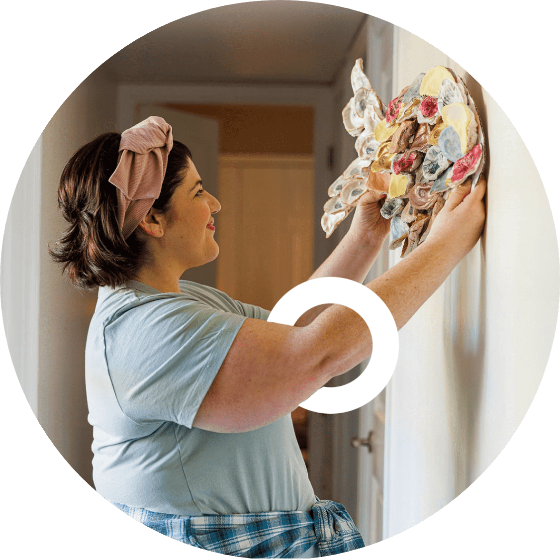 A CIDP patient hanging up some art on the wall.