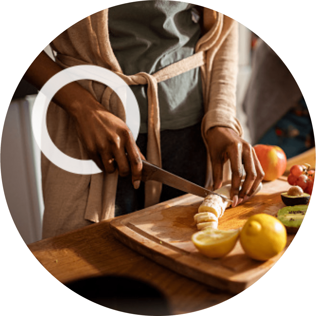 A woman cutting bananas depicts that loss of grip strength can be a sign of MMN.